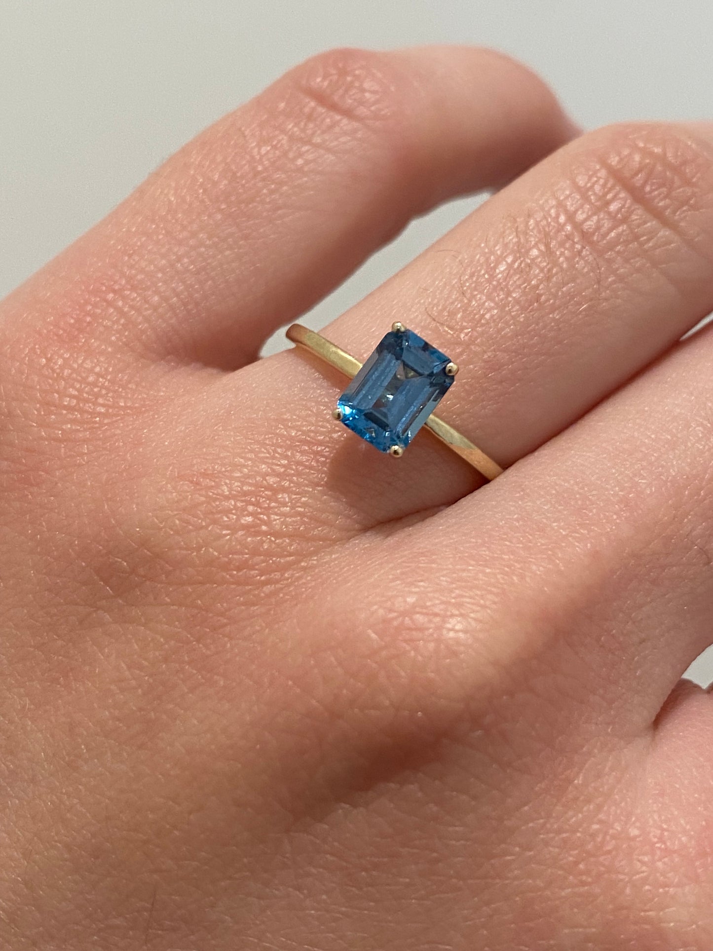 EMERALD CUT BLUE TOPAZ SOLITAIRE RING