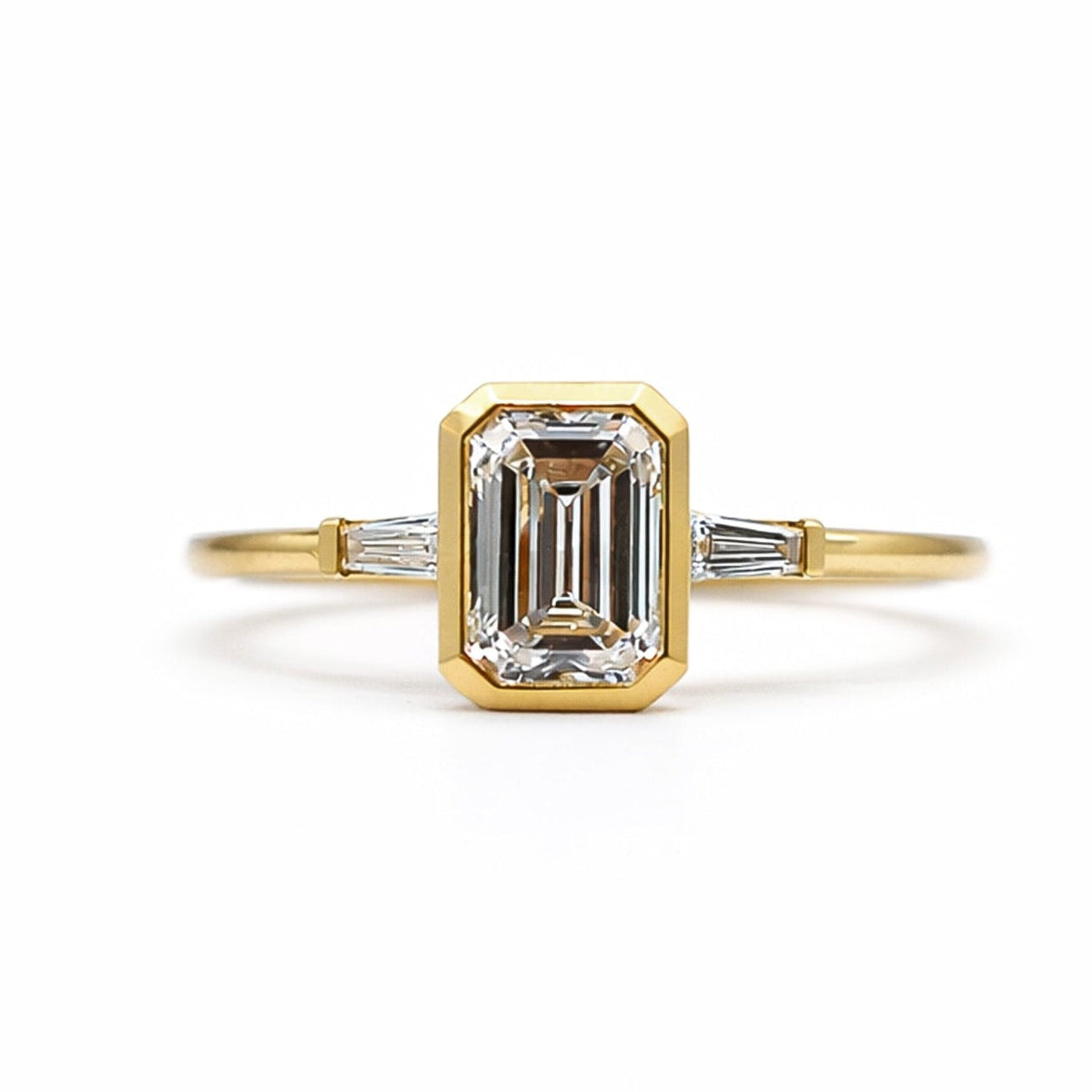 18K EMERALD CUT DIAMOND BEZEL THREE STONE RING
